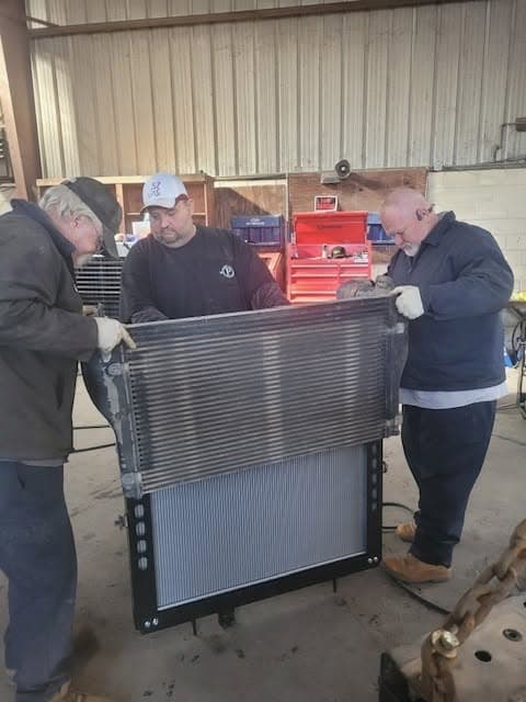 The Port City Repair team working together on a radiator